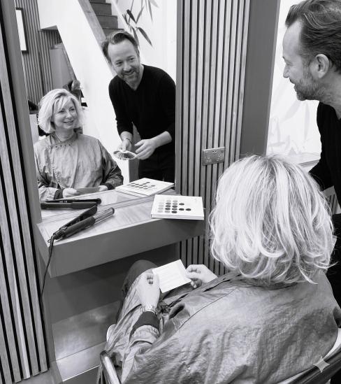 Hair colour consultation at Uffizi Hair salon, Battersea - stylist showing colour swatches to a client